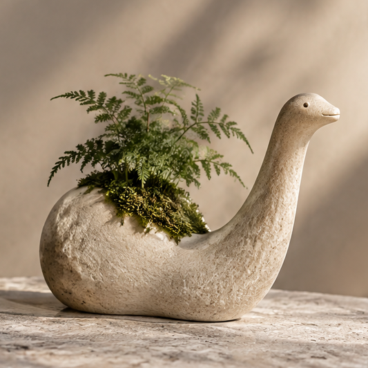Cream long-neck animal-shaped textured planter with delicate foliage, without text overlay
