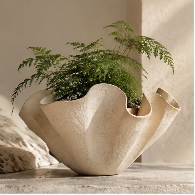 Cream wave-shaped textured planter styled with green foliage, without text overlay