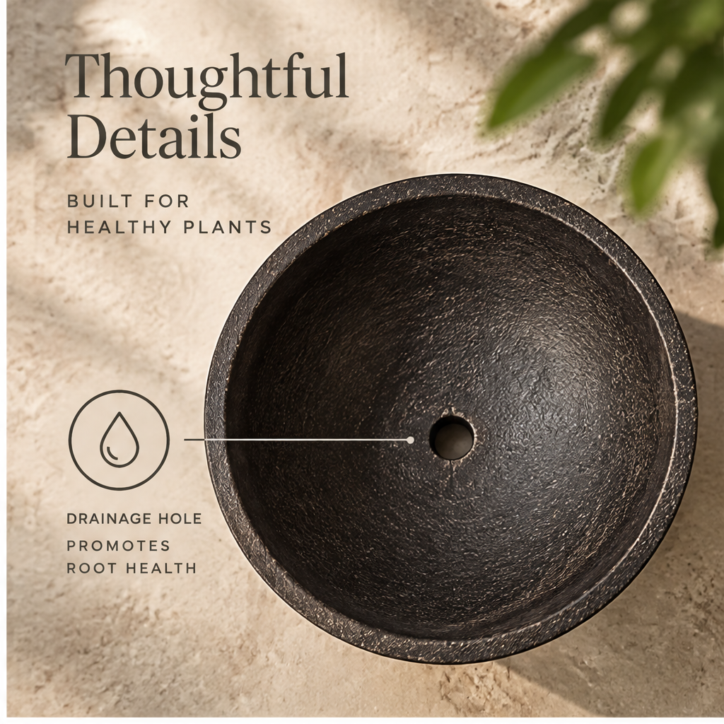 Empty dark orb-footed planter showing rounded bowl and spherical feet