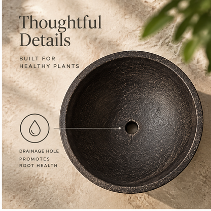 Empty dark orb-footed planter showing rounded bowl and spherical feet