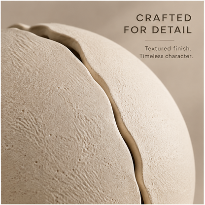 Cream round planter showing its sculptural split-shell design with foliage